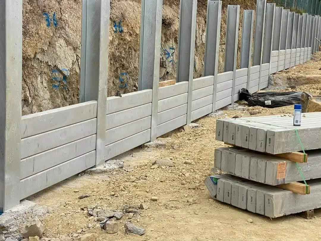Concrete sleeper retaining wall construction with steel posts and sleepers